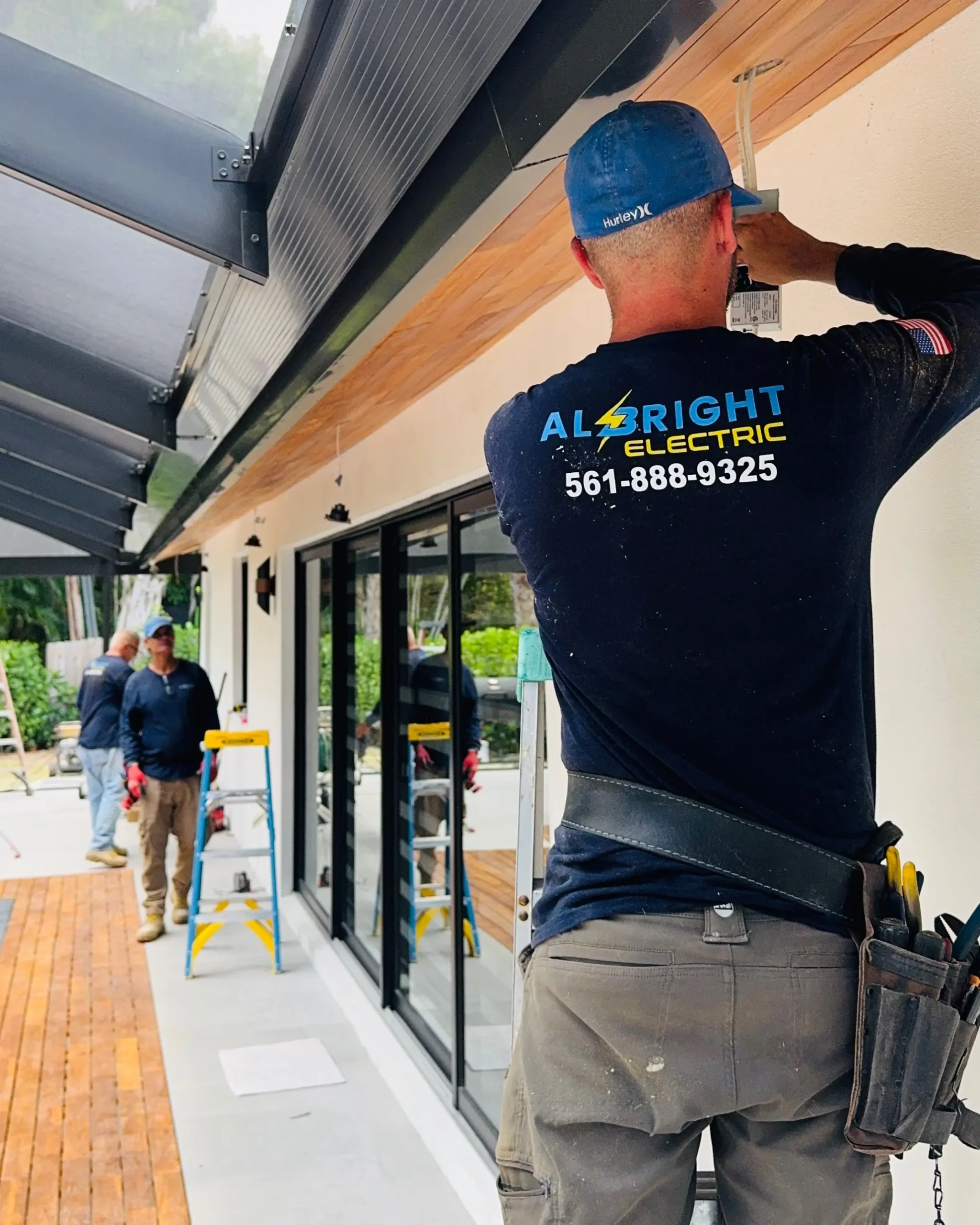 An Albright-branded technician working above a storefront entrance